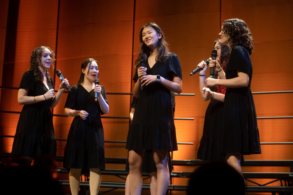 girls singing on stage