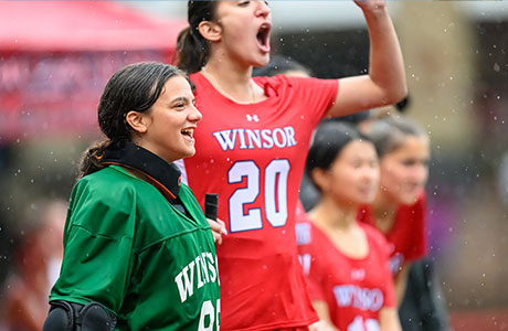 The Winsor School student cheering for field hockey team