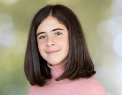 Isabella is a female student wearing a pink sweater