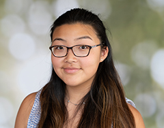 Young female student with glasses and long brown hair