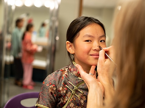 Winsor student getting costume and make-up on for opening night's performance