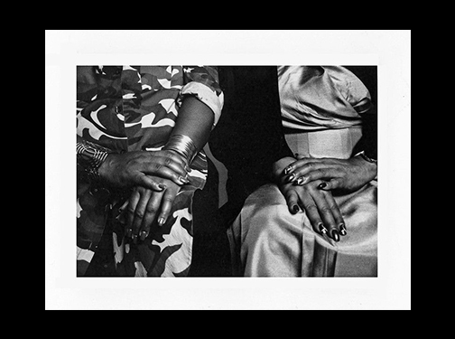 student black and white photograph of two women sitting with hands on lap