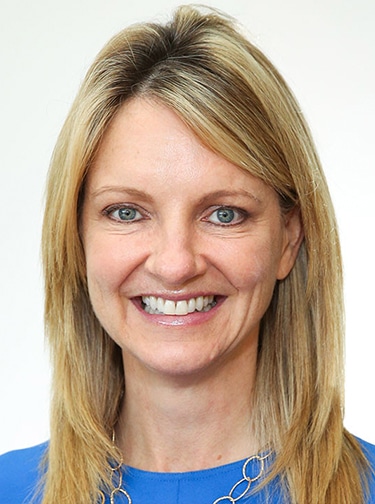 white woman with blonde hair and blue shirt