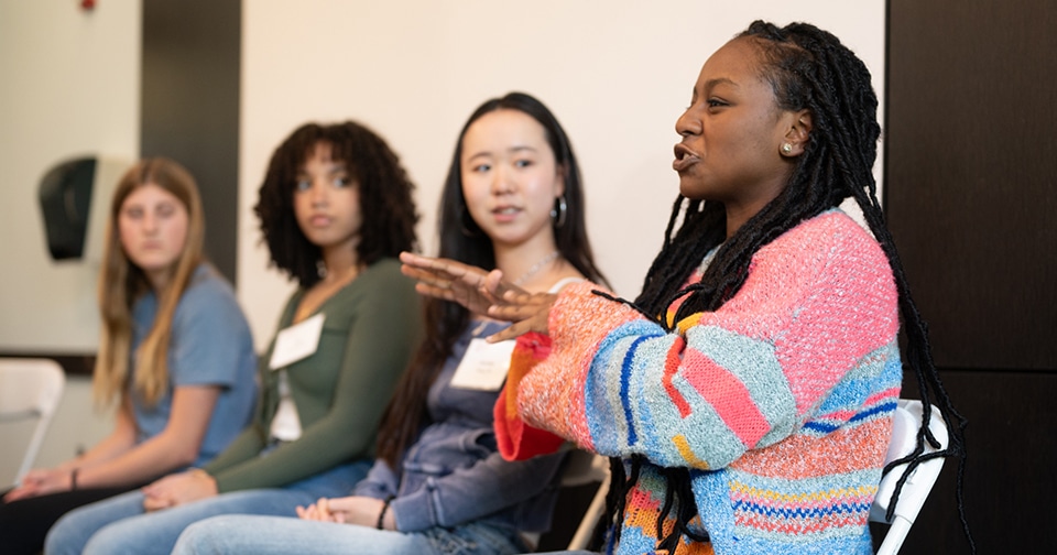 A diverse panel of four students answering questions