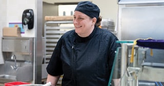 Female chef in a school cafeteria kitchen