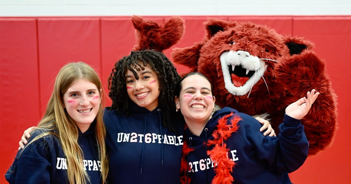 Three students and a school mascot