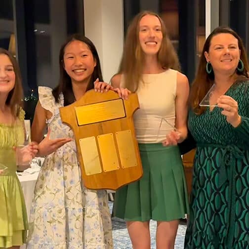 Female students holding the awards they won