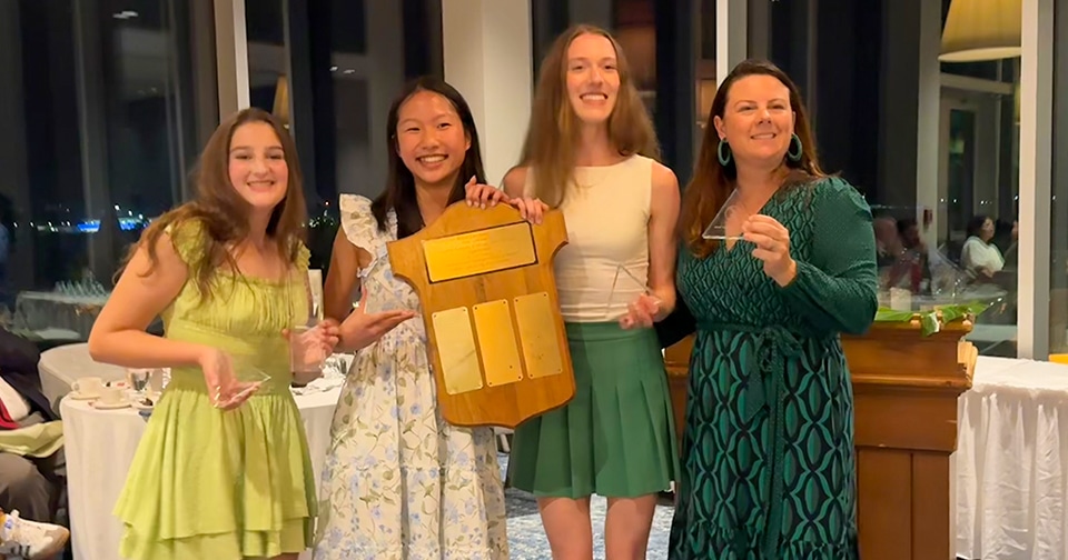 Female students holding the awards they won