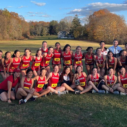 Cross country athletes pose with a trophy