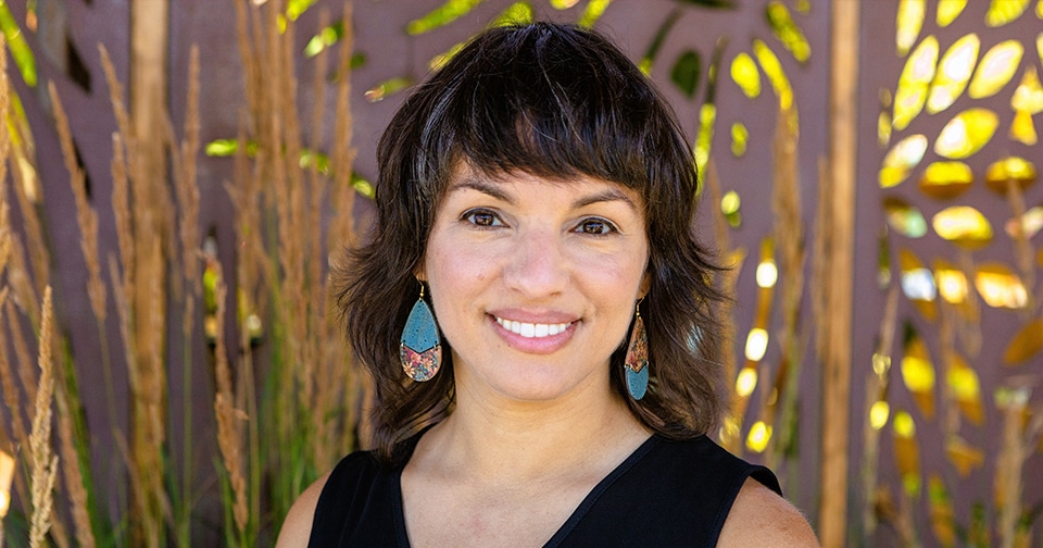 Headshot of female author Mónica Guzmán